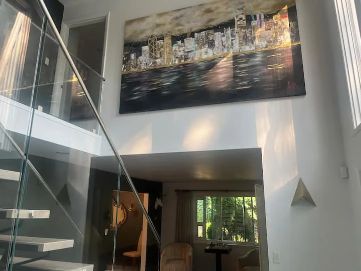 Artwork displayed above the Posh Pittsburgh staircase