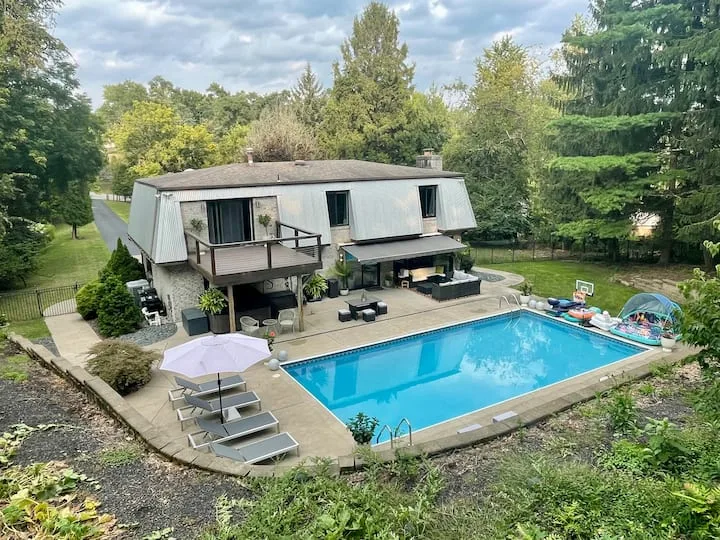 Outdoor pool beside the Posh Pittsburgh home and terrace